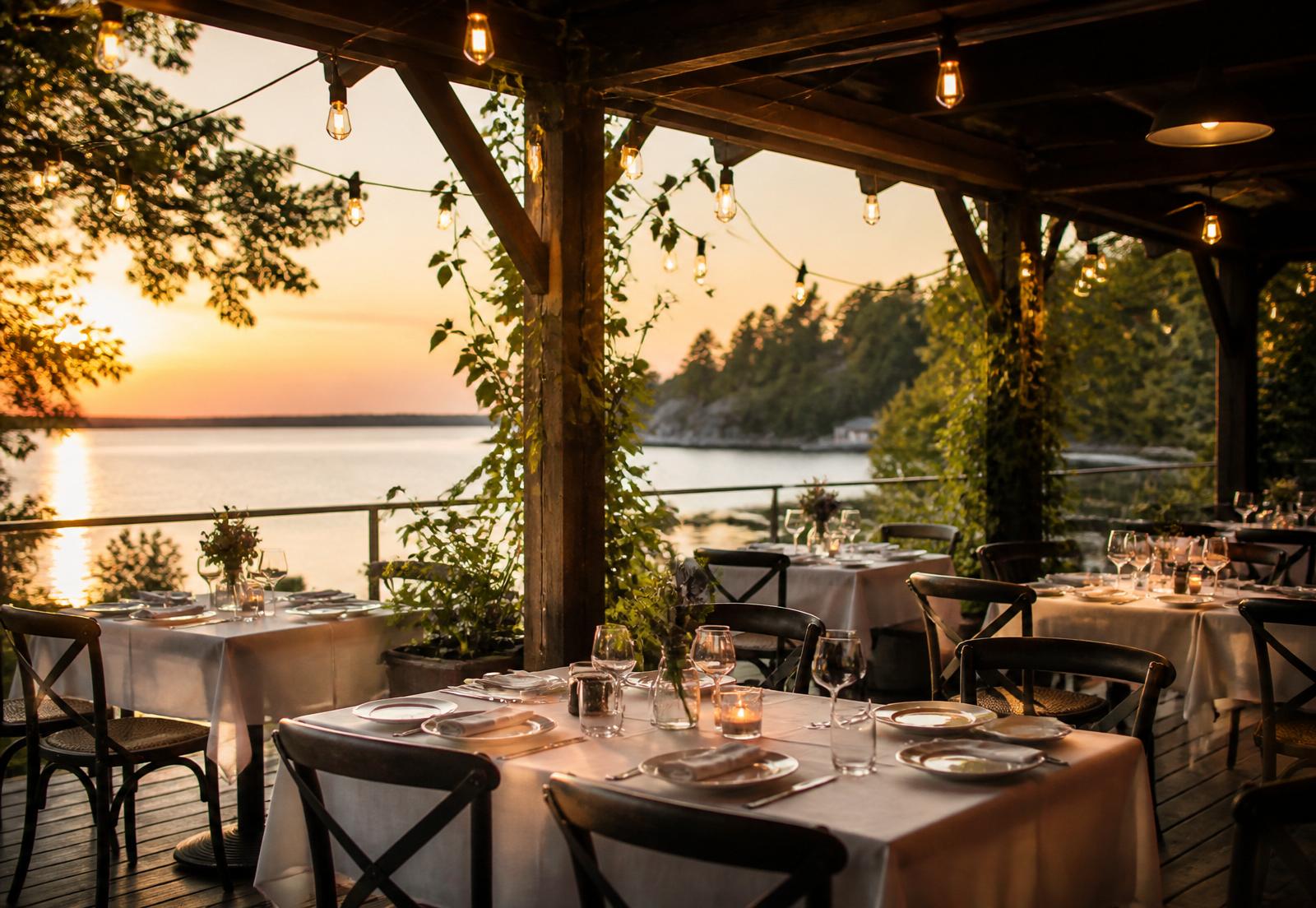 Boathouse Eatery patio at golden hour with Edison string lights